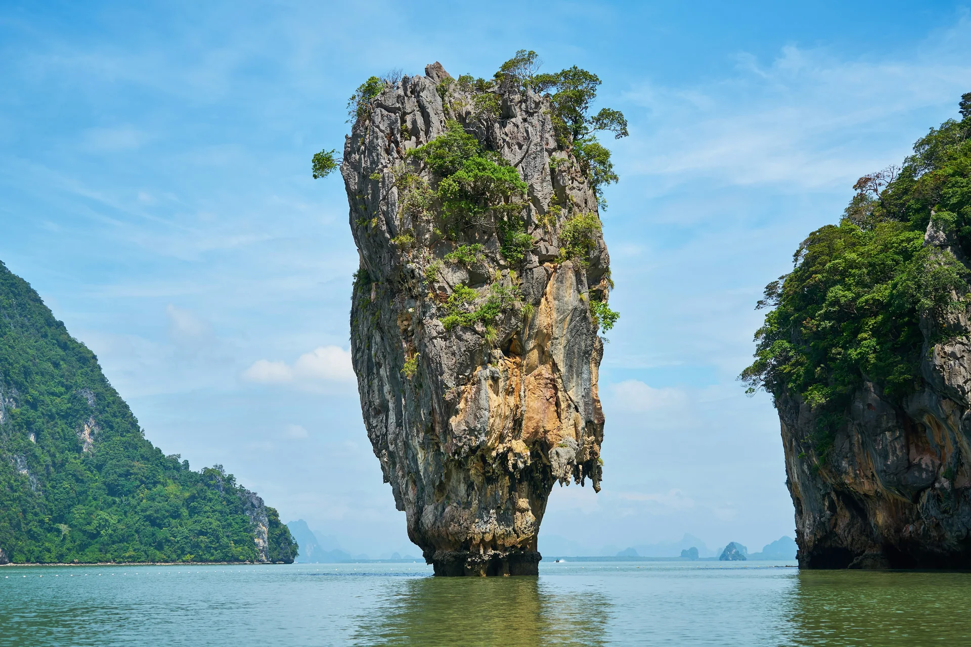 Ko Tapu, the limestone needle rock known as James Bond Island, rising from the turquoise water of Phang Nga Bay between two larger karst islands